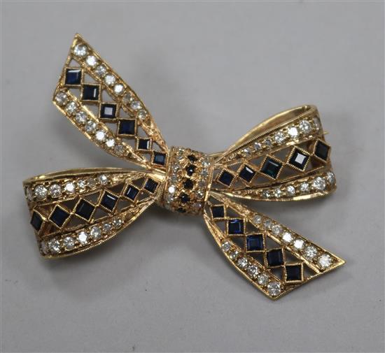 A 9ct yellow gold, sapphire and diamond bow brooch, 40mm.